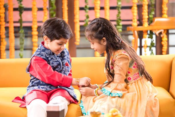 Girl tying rakhi on her brother's wrist on the occasion of Raksha Bandhan festival